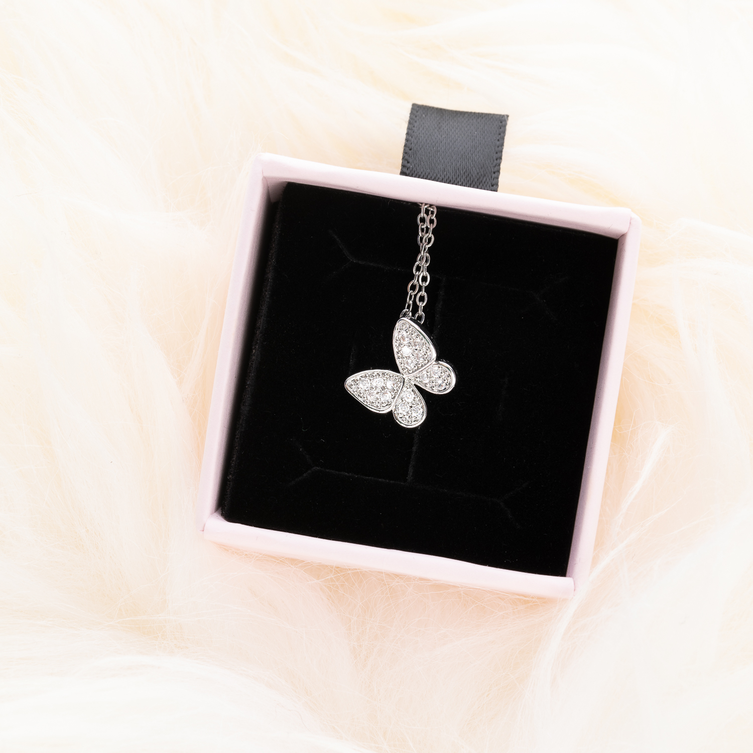 Blissful Butterfly Necklace in a pink jewelry box.