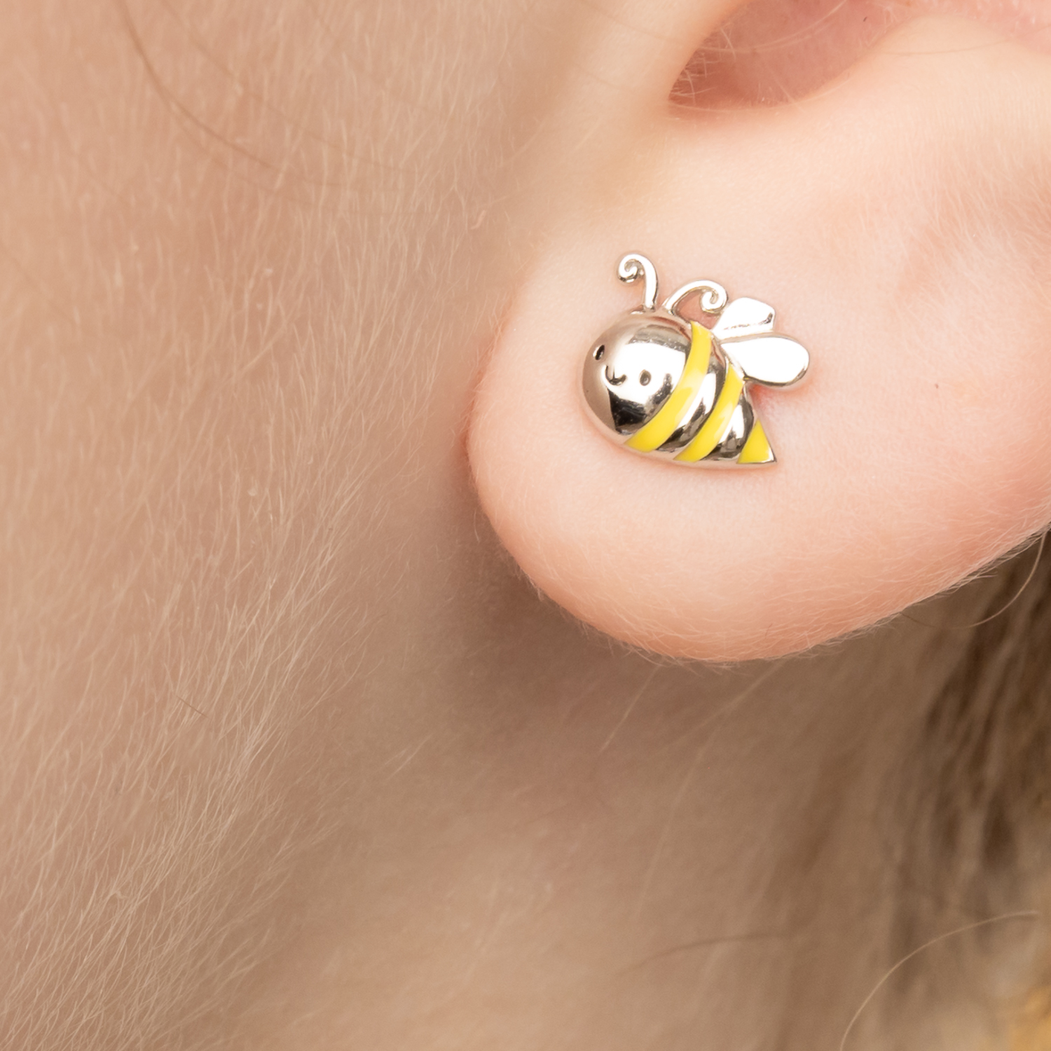 Teen girl wearing the "Bee Happy Earrings".