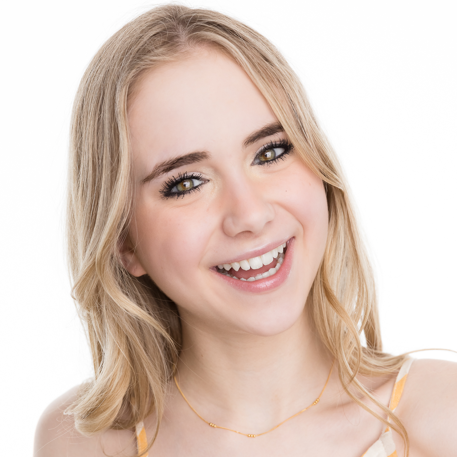 Teen girl smiling, she has long, curled, blonde hair, and is wearing the "Smile In Morse Code Necklace".