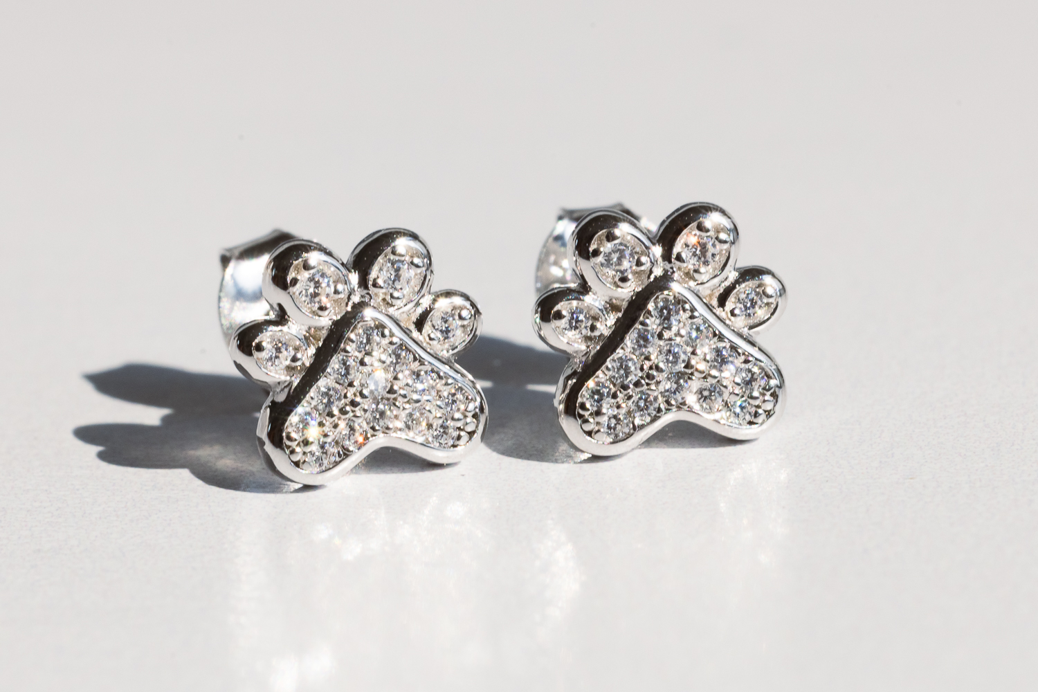 The "Playful Paw Earrings" on a white background.